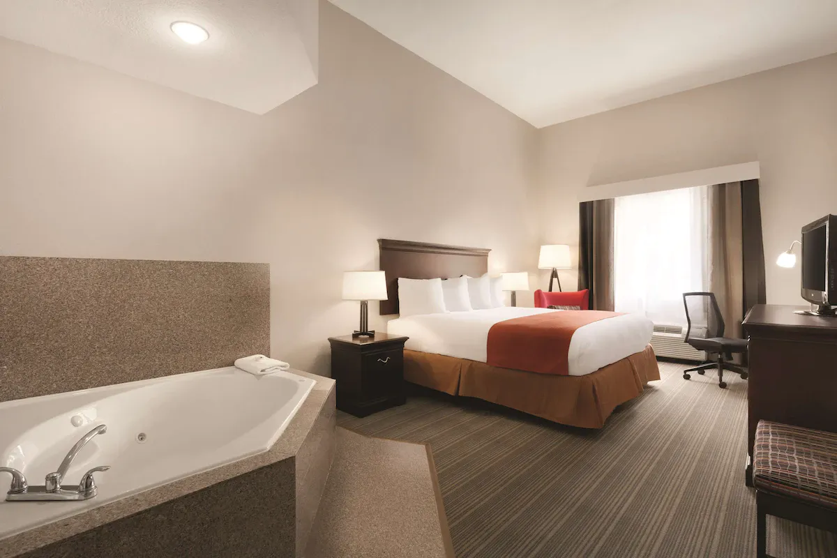 Image of Country Inn & Suites by Radisson, St. Petersburg – Clearwater, FL with hot tub in room