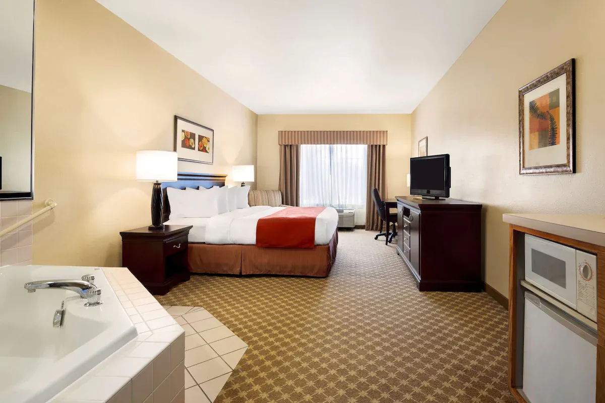 Image of Country Inn & Suites by Radisson, Clinton, IA with hot tub in room