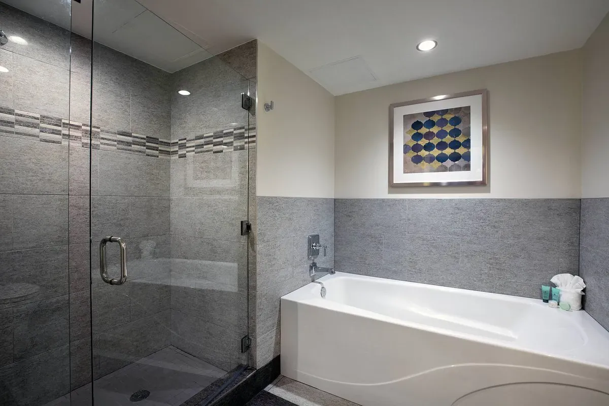 Image of Ambassador Hotel Wichita, Autograph Collection with hot tub in room