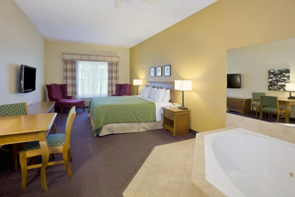 Image of Country Inn & Suites by Radisson, Salina, KS with hot tub in room
