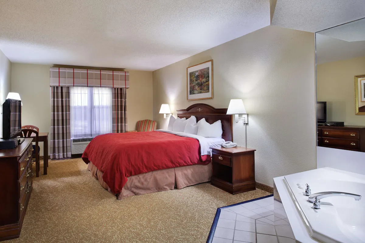 Image of Country Inn & Suites by Radisson, Louisville South, KY with hot tub in room