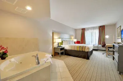 Image of Country Inn & Suites by Radisson, Charleston North, SC with hot tub in room