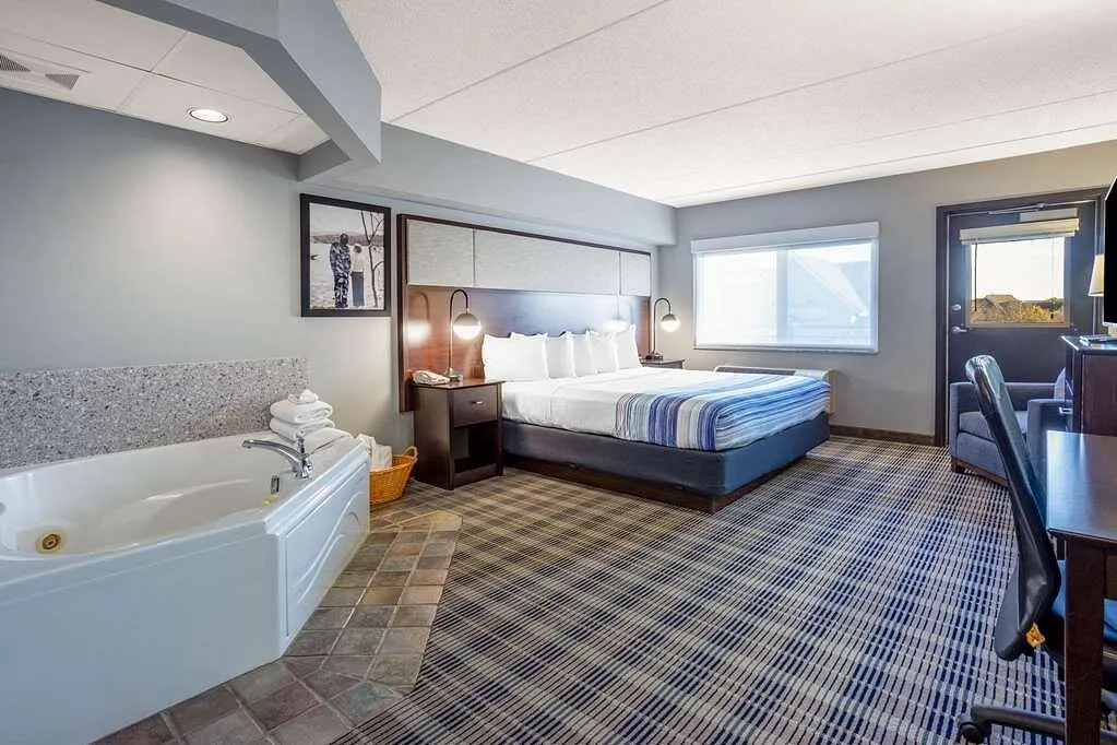 Image of AmericInn by Wyndham Madison South with hot tub in room